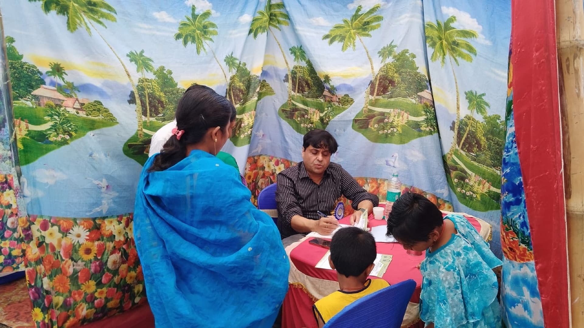 Doctor consulting patients at free health camp